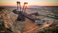 Aerial view of a back lit Bucket Wheel Excavators working in a lignite surface mine at sunset